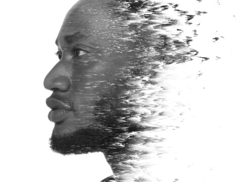 A double exposure portrait of a man combined with digital art.