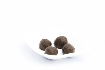 Bhaang Ki Goli Or Bhang Ka Gola Is Made Of Is Herbal Edible Balls Made Of Cannabis Leaves Paste And Is Consumed Specially On Indian Festival Holi For Fun. Isolated On White Background With Copy Space