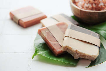 Handmade soap bars and green leaves