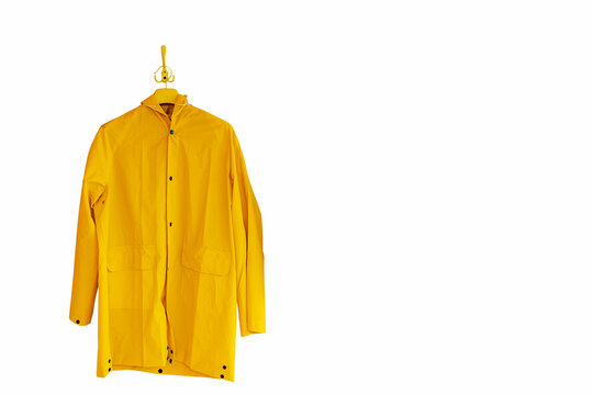 A yellow raincoat hangs on a hanger. Isolate on white background