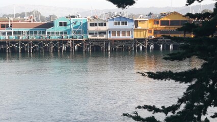 Colorful wooden houses on piles, pillars or pylons, ocean sea water, historic Old Fisherman's...