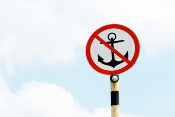 Forbidding sign of the anchor do not throw on the background of the sky. copy space