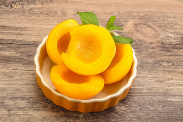 Sweet ripe canned peaches with mint