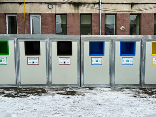 Naklejka premium Different colored selective trash bins on the city street.