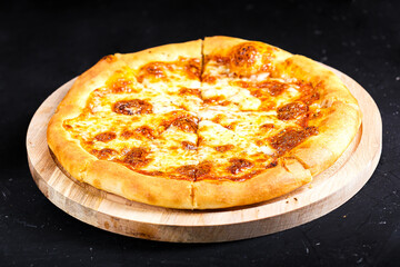 on a kitchen wooden cutting board, Georgian four cheese pizza, on a black isolated background