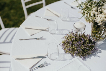 Wedding. Banquet. Chairs and honeymooners table decorated with candles. Beautiful decoration, beautiful flowers.