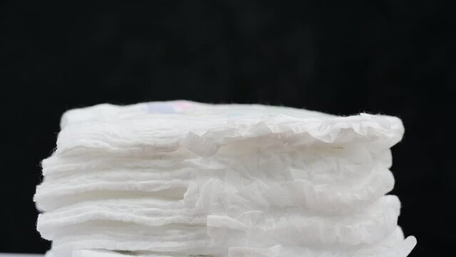 Pile of baby diaper panties diaper isolated on background, close-up, copy space, infant