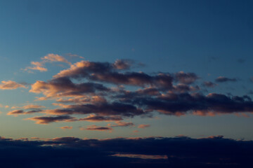 Spring blue sky background with orange purple clouds in the evening