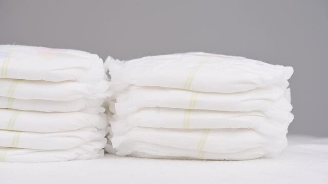 Pile of baby diaper panties diaper isolated on background, close-up, copy space, infant