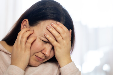 Young woman suffering of strong ear ache and tinnitus after COVID-19, ear disease, healthcare concept