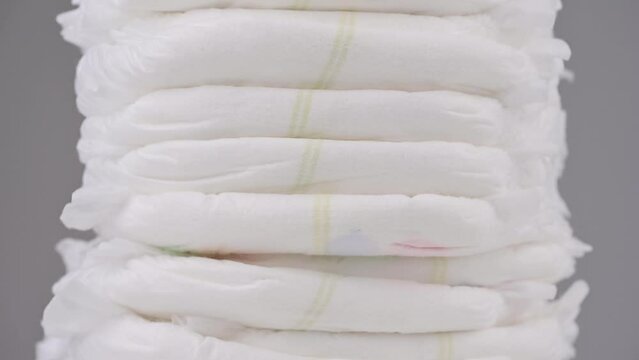 Pile of baby diaper panties diaper isolated on background, close-up, copy space, infant