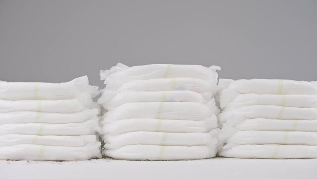 Pile of baby diaper panties diaper isolated on background, close-up, copy space, infant