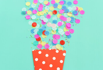 Party colorful confetti over pastel blue background. Top view, flat lay