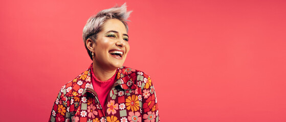 Cheerful hipster woman smiling in a studio - obrazy, fototapety, plakaty