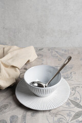 ceramic dishes on ceramic tiles with a pattern, vertical format