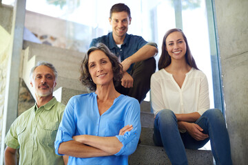 Welcome to our happy home. Shot of a mother and father standing in front of their adult children on...