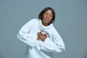 African american woman choking feeling pain ache touching chest suffer from heartache, shortness of breath, panic attack