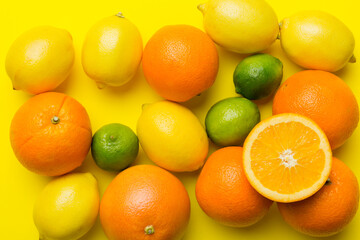 Flat lay of citrus fruits like lime, orange and lemon with lemon tree leaves on light colored background. Space for text healthy concept. Top view