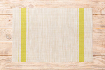 Top view of green tablecloth for food on wooden background. Empty space for your design