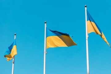 The national flag of Ukraine flutters in the wind. The national symbol of the Ukrainian people on the building. City Dnipro