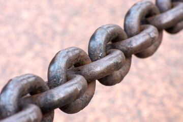 Old rusty anchor chain. The chain links are out of focus.