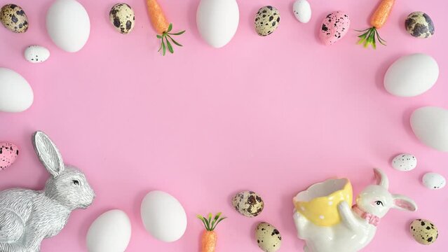 Spring Easter holidays stop motion animation with eggs and rabbits make copy space frame on pastel pink background