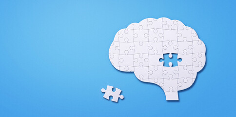 Jigsaw puzzle in shape of human brain isolated on blue background