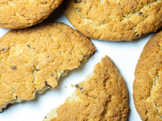 Oatmeal raisin cookies on a white background. Sweets. Broken tea biscuits.