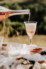 Pouring Champagne Drink in Wineglass Closeup Photo