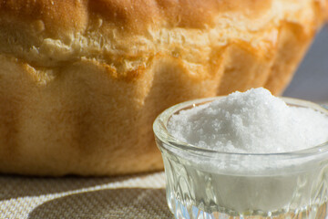 Salt and homemade bread on the table. Simple traditional food.