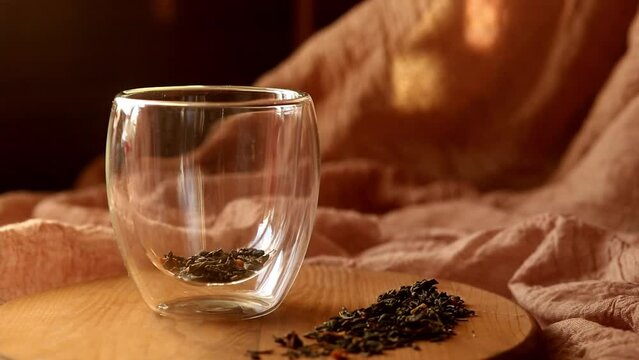 Brew dry herbal flavored green tea in a glass cup. Pour boiling water over tea. Steam over a cup of tea