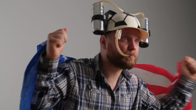 American in beer helmet watching sports channel