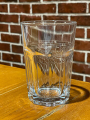 Empty tall glass on a wooden table