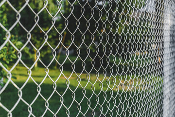 Close up, steel wire mesh fence. Against the backdrop of nature.