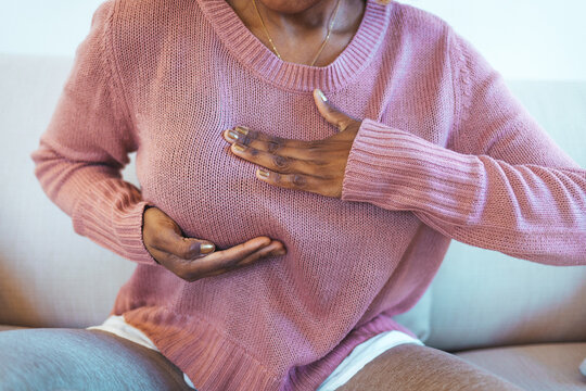 Young African American Woman Palpating Her Breast By Herself That She Concern About Breast Cancer. Healthcare And Breast Cancer Concept. Mature Woman Doing Self Breast Exam At Home