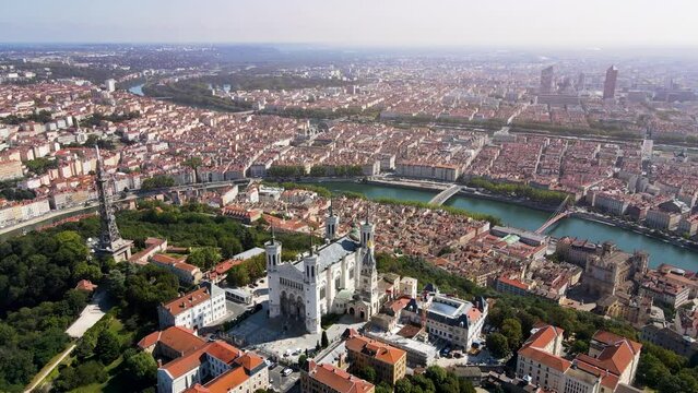 Lyon panorama with Fourviere basilica, Part-Dieu city center Rhone and Saone rivers, France. Aerial footage of famous touristic landmarks, French city of lights. Sunny warm summer day, blue sky.