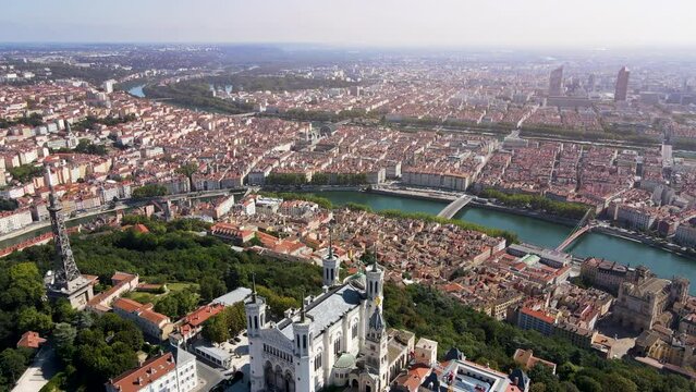 Lyon panorama with Fourviere basilica, Part-Dieu city center Rhone and Saone rivers, France. Aerial footage of famous touristic landmarks, French city of lights. Sunny warm summer day, blue sky.