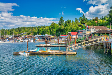 Fototapeta na wymiar Cowichan Bay boats and wooden homes on a beautiful summer day, Vancouver Island - Canada.