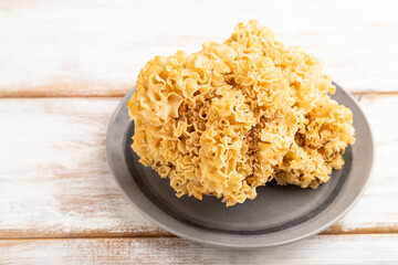 Raw Sparassis (Cauliflower Mushroom) on white, side view, close up.