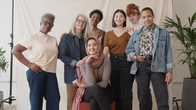 Slow motion of confident multiethnic women looking at camera and smiling in celebration of International Women's Day
