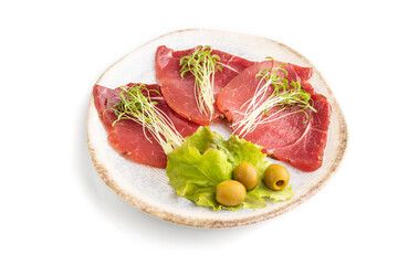 Slices of smoked salted meat with cilantro microgreen isolated on white. Side view, close up.