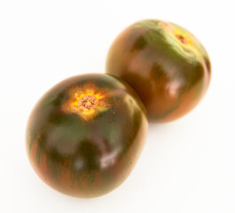 Fototapeta premium ripe black tomatoes on a white background