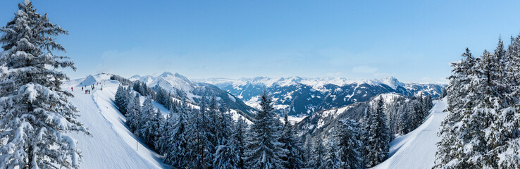 Skiing slope high up in the snow covered forest and mountains