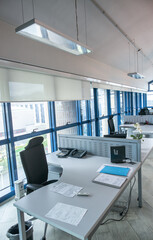 Empty row of desks and chairs in the modern office building.