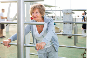 An elderly woman trains outdoors