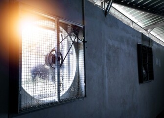 Close up of industrial exhaust fan, Ventilation of plant building  with shiny light.