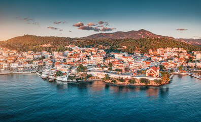 Orthodox Church of Taxiarch Angels among Houses and villas in a resort town Neos Marmaras in...