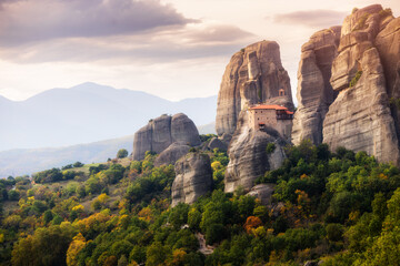 Fototapeta na wymiar Holy Monastery of Saint Nicholas Anapafsas on a rock cliff at Meteora. Travel and pilgrim must visit places in Greece
