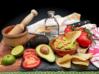 Homemade Organic Guacamole, tequila and Tortilla Chips. Selective focus.
