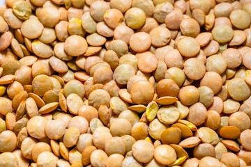 Closeup photo of natural dried brown lentils rotating
